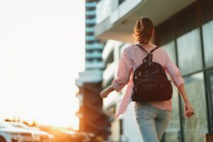Newton Financial RESPs - A university or college campus scene with a student walking toward a building, carrying a backpack, shot in a warm, natural, professional style2